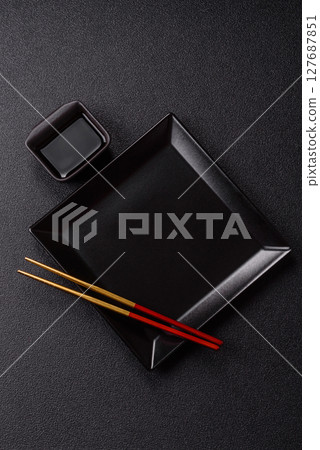 An empty plate with chopsticks for Japanese or Chinese food An empty plate with chopsticks for Japanese or Chinese food 127687851