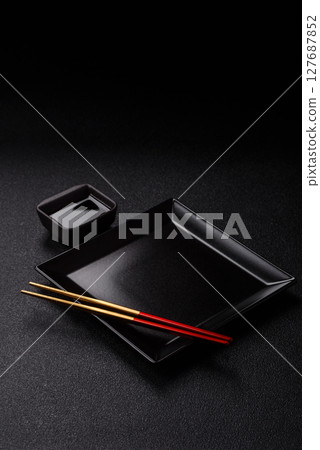 An empty plate with chopsticks for Japanese or Chinese food An empty plate with chopsticks for Japanese or Chinese food 127687852
