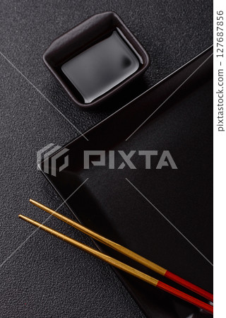 An empty plate with chopsticks for Japanese or Chinese food An empty plate with chopsticks for Japanese or Chinese food 127687856