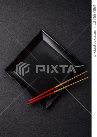 An empty plate with chopsticks for Japanese or Chinese food 127687864