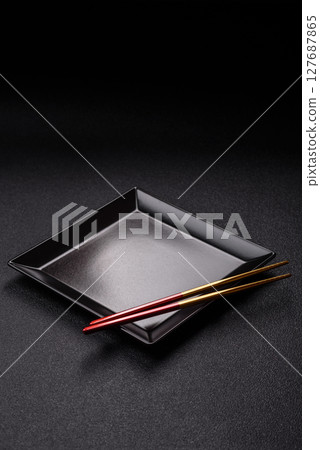 An empty plate with chopsticks for Japanese or Chinese food An empty plate with chopsticks for Japanese or Chinese food 127687865
