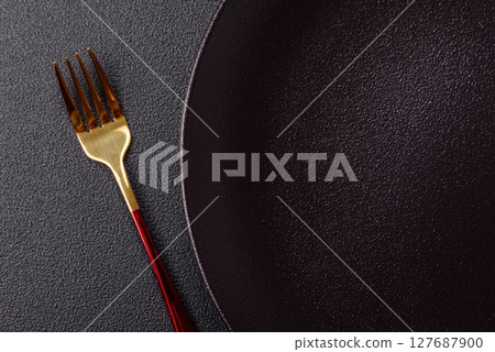 Empty plate with fork, cutlery for dinner table Empty plate with fork, cutlery for dinner table 127687900