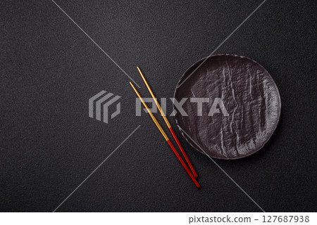 An empty plate with chopsticks for Japanese or Chinese food 127687938