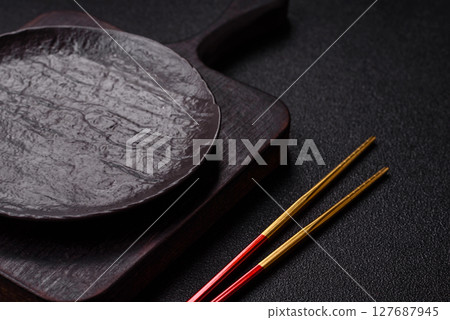 An empty plate with chopsticks for Japanese or Chinese food An empty plate with chopsticks for Japanese or Chinese food 127687945