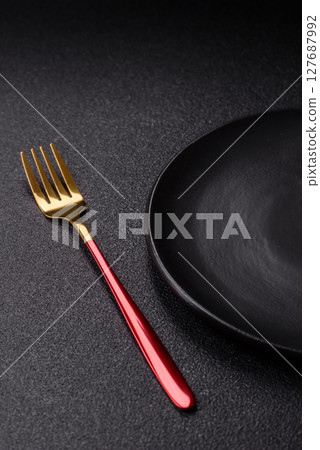 Empty plate with fork, cutlery for dinner table Empty plate with fork, cutlery for dinner table 127687992