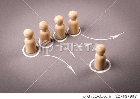 Leadership and Delegation Concept with Wooden Figures and Arrows on Gray Background 127687998