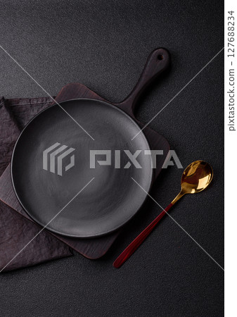 Empty plate with spoon, cutlery for dinner table 127688234