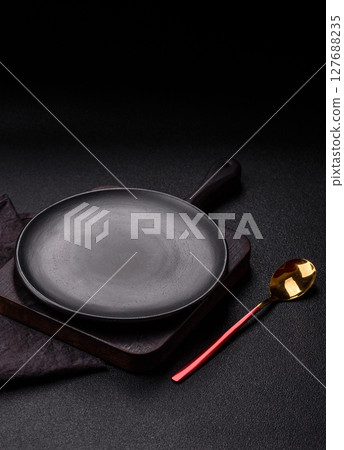 Empty plate with spoon, cutlery for dinner table 127688235