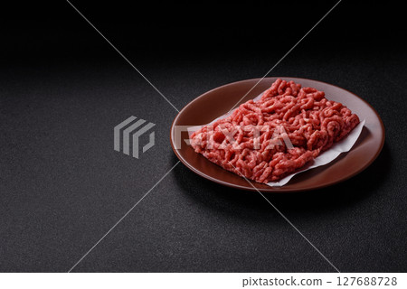 Stuffing or ground raw beef or pork with salt and spices 127688728