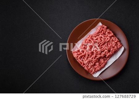 Stuffing or ground raw beef or pork with salt and spices 127688729