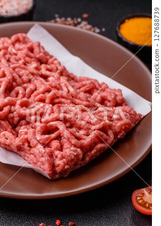Stuffing or ground raw beef or pork with salt and spices 127688739