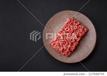 Stuffing or ground raw beef or pork with salt and spices 127688745