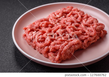 Stuffing or ground raw beef or pork with salt and spices 127688762