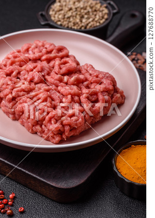 Stuffing or ground raw beef or pork with salt and spices 127688770