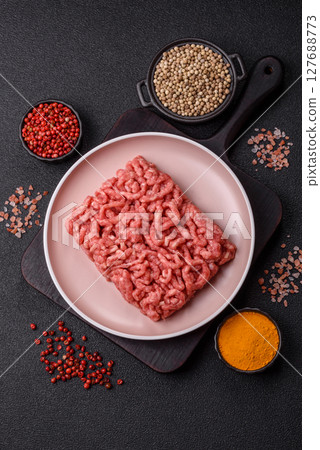 Stuffing or ground raw beef or pork with salt and spices 127688773