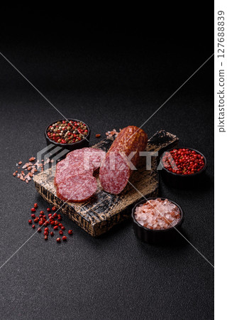 Sliced salami sausage, smoked meat, delicious deli snacks Sliced salami sausage, smoked meat, delicious deli snacks 127688839