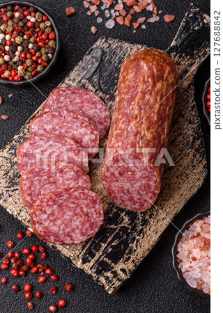 Sliced salami sausage, smoked meat, delicious deli snacks 127688842