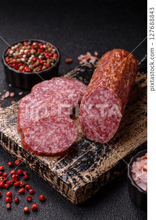 Sliced salami sausage, smoked meat, delicious deli snacks 127688843