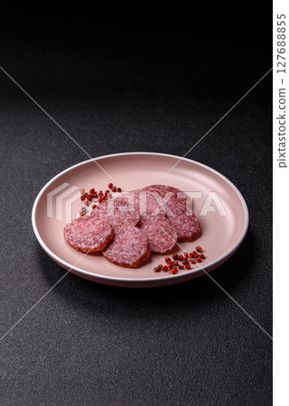 Sliced salami sausage, smoked meat, delicious deli snacks 127688855
