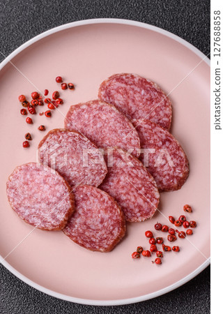 Sliced salami sausage, smoked meat, delicious deli snacks 127688858