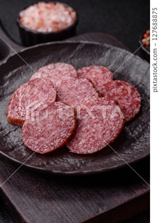 Sliced salami sausage, smoked meat, delicious deli snacks Sliced salami sausage, smoked meat, delicious deli snacks 127688875