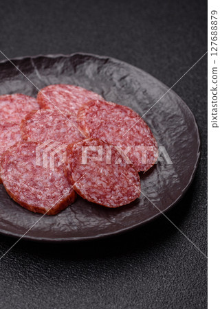 Sliced salami sausage, smoked meat, delicious deli snacks 127688879