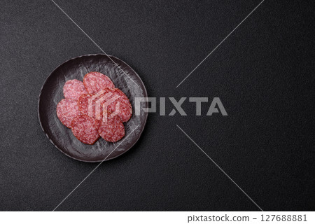 Sliced salami sausage, smoked meat, delicious deli snacks Sliced salami sausage, smoked meat, delicious deli snacks 127688881