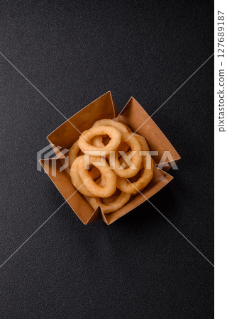 Onion rings or squid rings fries crispy, savory with sauce Onion rings or squid rings fries crispy, savory with sauce 127689187