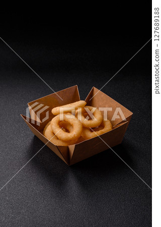 Onion rings or squid rings fries crispy, savory with sauce 127689188