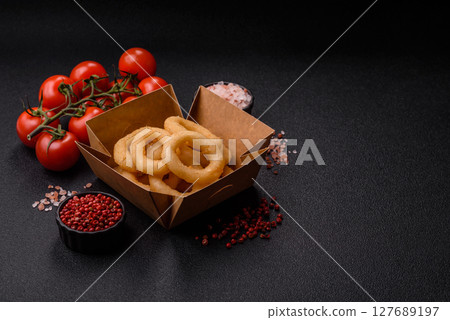 Onion rings or squid rings fries crispy, savory with sauce 127689197