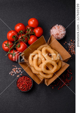 Onion rings or squid rings fries crispy, savory with sauce Onion rings or squid rings fries crispy, savory with sauce 127689199