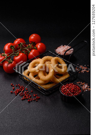 Onion rings or squid rings fries crispy, savory with sauce Onion rings or squid rings fries crispy, savory with sauce 127689204