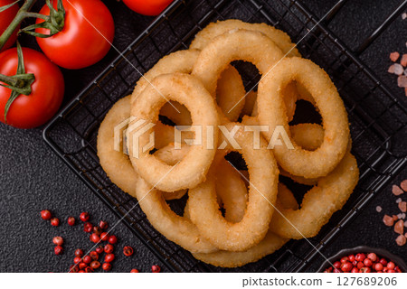 Onion rings or squid rings fries crispy, savory with sauce Onion rings or squid rings fries crispy, savory with sauce 127689206