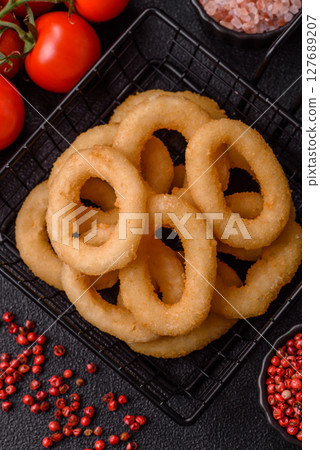 Onion rings or squid rings fries crispy, savory with sauce Onion rings or squid rings fries crispy, savory with sauce 127689207