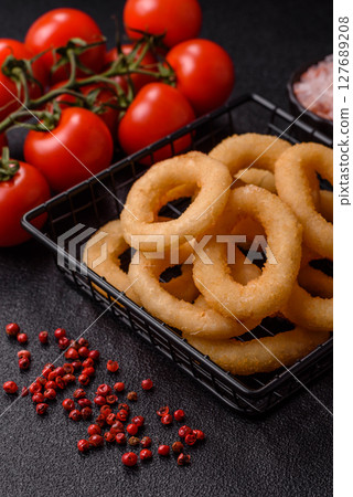 Onion rings or squid rings fries crispy, savory with sauce 127689208