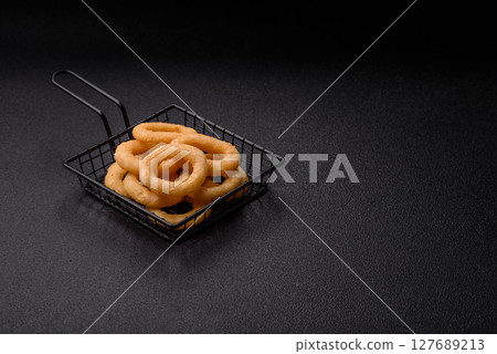 Onion rings or squid rings fries crispy, savory with sauce 127689213