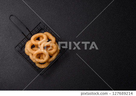 Onion rings or squid rings fries crispy, savory with sauce Onion rings or squid rings fries crispy, savory with sauce 127689214