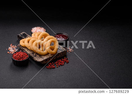 Onion rings or squid rings fries crispy, savory with sauce Onion rings or squid rings fries crispy, savory with sauce 127689229