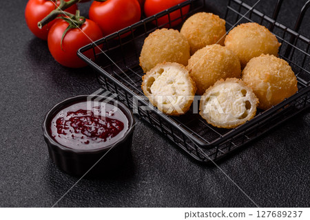 Cheese fried balls or croquettes with potatoes or rice 127689237