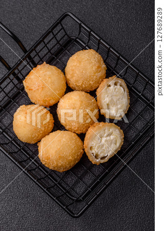 Cheese fried balls or croquettes with potatoes or rice Cheese fried balls or croquettes with potatoes or rice 127689289