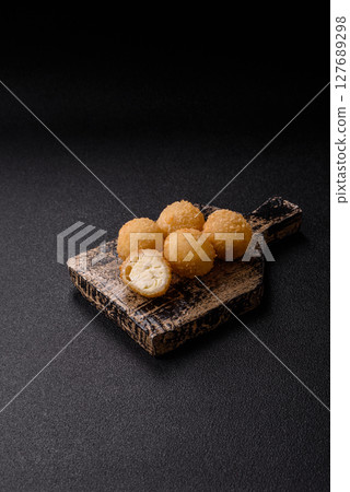Cheese fried balls or croquettes with potatoes or rice 127689298