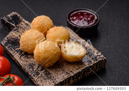 Cheese fried balls or croquettes with potatoes or rice Cheese fried balls or croquettes with potatoes or rice 127689303