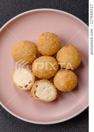Cheese fried balls or croquettes with potatoes or rice 127689317