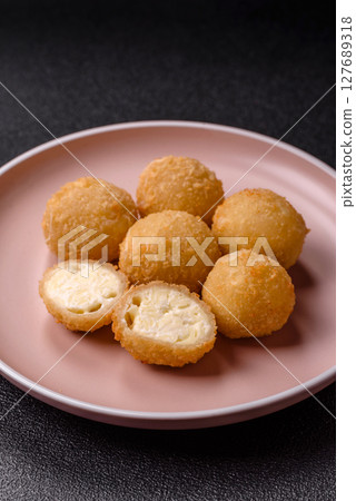 Cheese fried balls or croquettes with potatoes or rice Cheese fried balls or croquettes with potatoes or rice 127689318