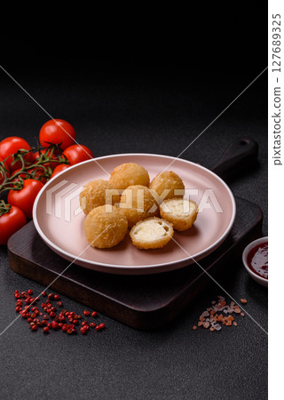Cheese fried balls or croquettes with potatoes or rice 127689325