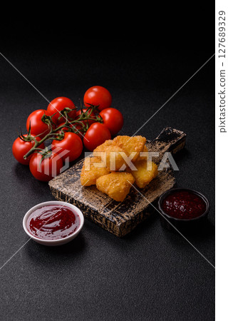 Fried mozzarella or brie cheese with cranberry or raspberry sauce 127689329