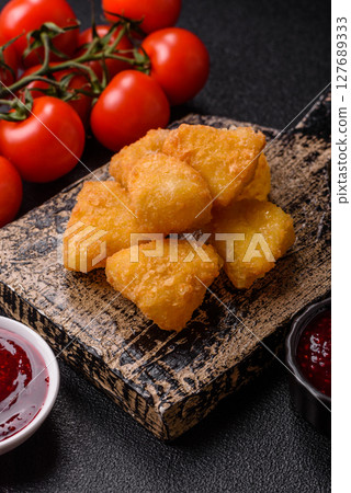 Fried mozzarella or brie cheese with cranberry or raspberry sauce Fried mozzarella or brie cheese with cranberry or raspberry sauce 127689333