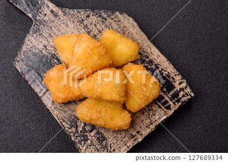 Fried mozzarella or brie cheese with cranberry or raspberry sauce 127689334
