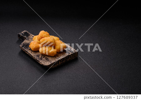 Fried mozzarella or brie cheese with cranberry or raspberry sauce 127689337