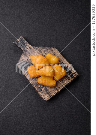 Fried mozzarella or brie cheese with cranberry or raspberry sauce 127689339